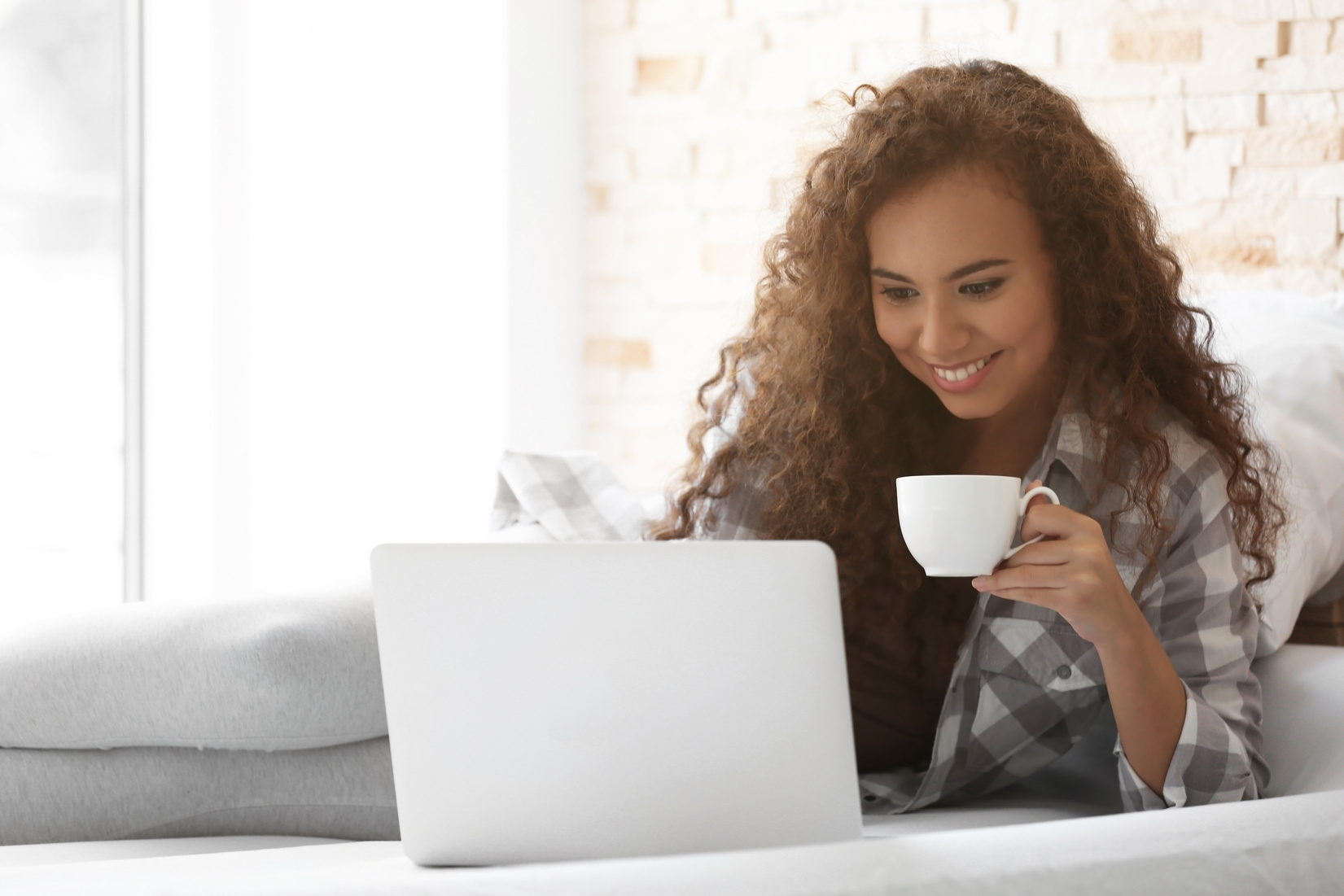 Woman with a Cup of Coffee Working on Computer